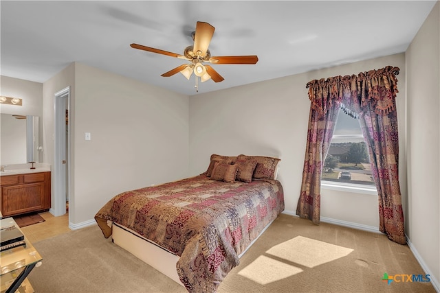 carpeted bedroom featuring connected bathroom and ceiling fan