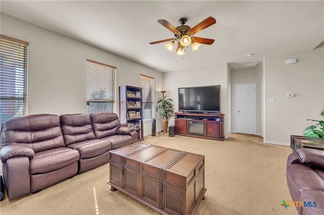 living room with ceiling fan, light colored carpet, and a wealth of natural light