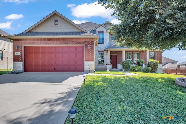 view of front facade with a front yard and a garage