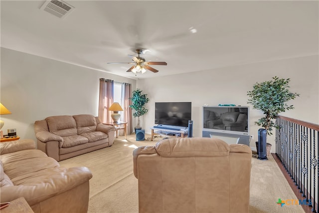 carpeted living room featuring ceiling fan