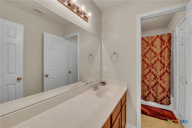 bathroom with tile patterned floors, shower / tub combo with curtain, and vanity