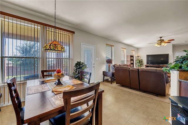 tiled dining area featuring ceiling fan