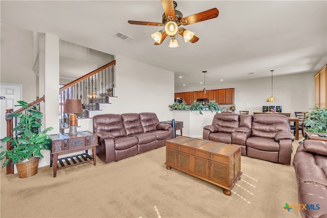 carpeted living room featuring ceiling fan