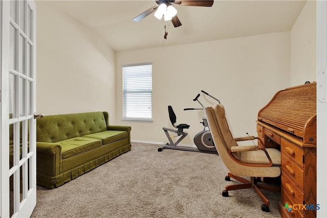 carpeted office space with ceiling fan