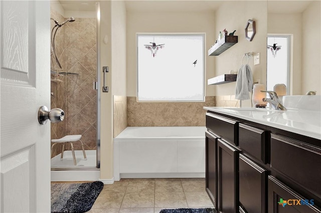 bathroom with vanity, tile patterned floors, and plus walk in shower