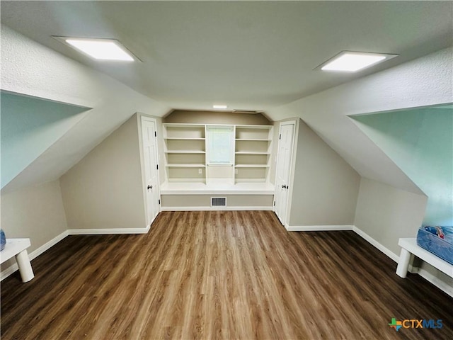 bonus room featuring dark hardwood / wood-style flooring and lofted ceiling