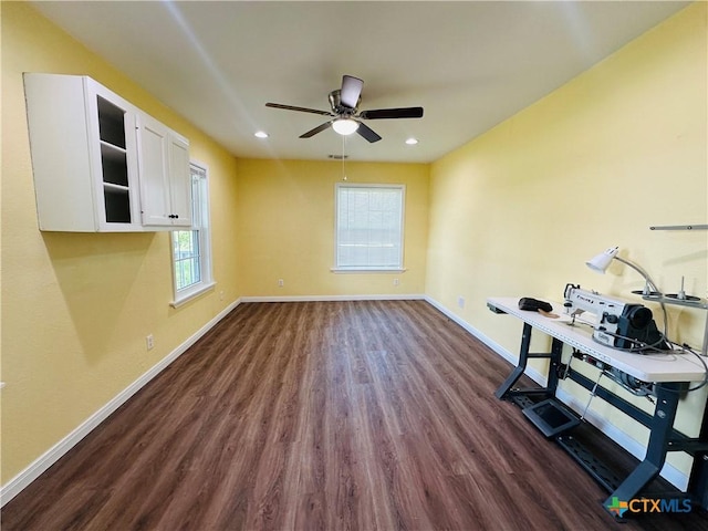 office space featuring ceiling fan and dark hardwood / wood-style flooring