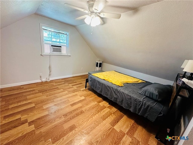 bedroom with lofted ceiling, a textured ceiling, ceiling fan, and cooling unit