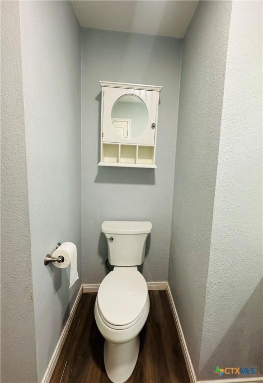 bathroom with toilet and hardwood / wood-style flooring