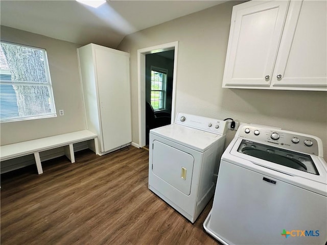 laundry area featuring dark hardwood / wood-style flooring, cabinets, and separate washer and dryer