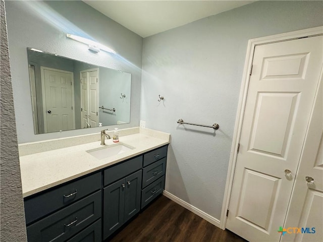 bathroom with hardwood / wood-style floors and vanity