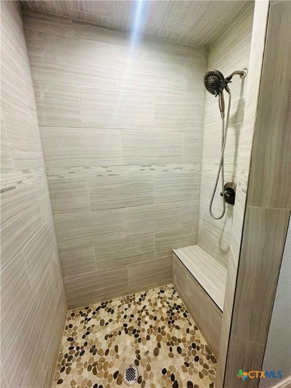 bathroom with a tile shower