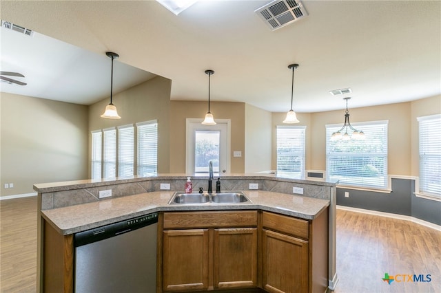 1126 Neuberry Cliffe, Temple, TX 76502 - kitchen featuring dishwasher, a sink, light wood-type flooring, brown cabinetry, and baseboards