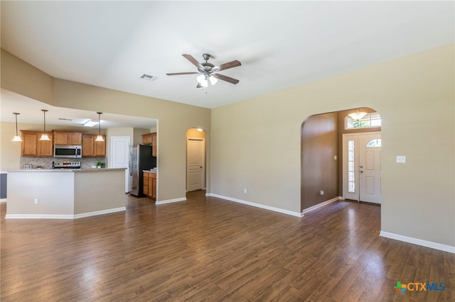 1126 Neuberry Cliffe, Temple, TX 76502 - unfurnished living room with arched walkways, ceiling fan, dark wood-style floors, and baseboards