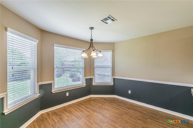 1126 Neuberry Cliffe, Temple, TX 76502 - unfurnished room featuring wood finished floors, plenty of natural light, a chandelier, and baseboards
