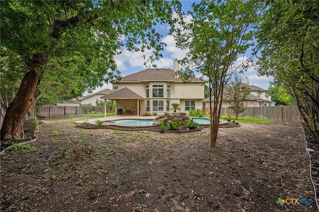 1018 Canyon Maple Rd, Pflugerville, TX 78660 - rear view of house featuring a chimney, a fenced backyard, a patio area, and a gazebo