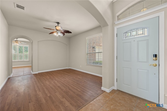 1018 Canyon Maple Rd, Pflugerville, TX 78660 - entryway with ceiling fan, arched walkways, baseboards, and wood finished floors