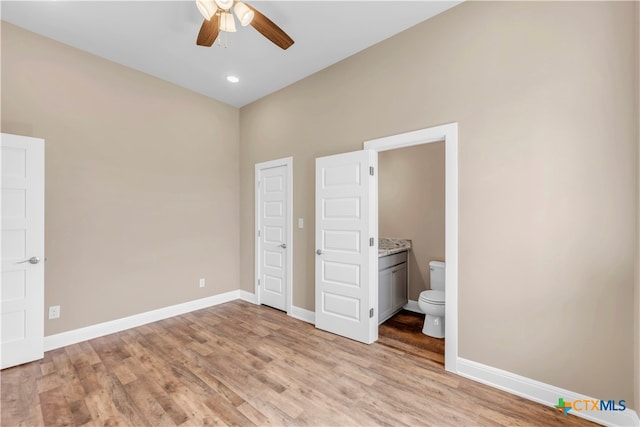 unfurnished bedroom featuring light hardwood / wood-style flooring, ceiling fan, and ensuite bathroom