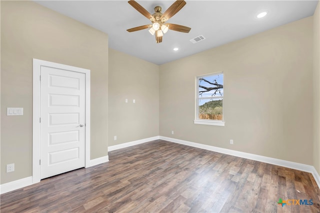 unfurnished room with dark wood-type flooring and ceiling fan