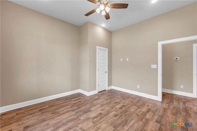 empty room with wood-type flooring and ceiling fan