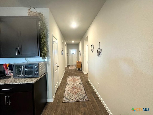 corridor featuring dark hardwood / wood-style floors