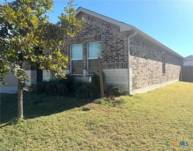 view of side of home featuring a lawn