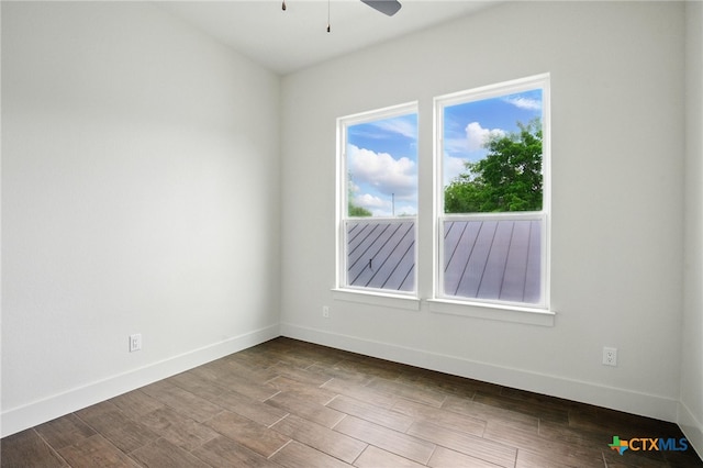 empty room with a ceiling fan, baseboards, and wood finished floors