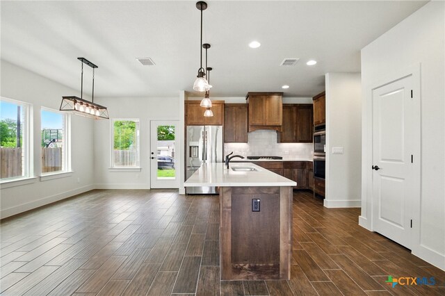 kitchen featuring light countertops, stainless steel appliances, visible vents, and a sink