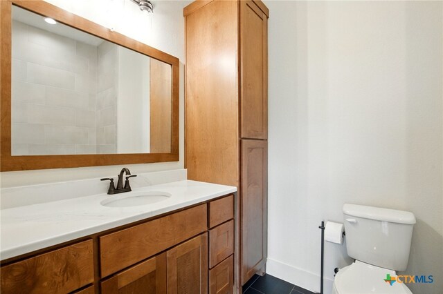 bathroom featuring toilet and vanity
