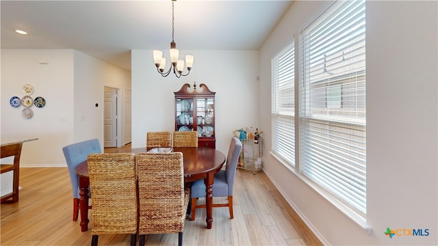 248 Teller Dr, Lockhart, TX 78644 - dining room featuring a chandelier, light wood-style floors, and baseboards