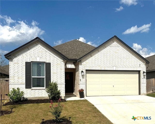248 Teller Dr, Lockhart, TX 78644 - view of front of home featuring brick siding, an attached garage, fence, and concrete driveway