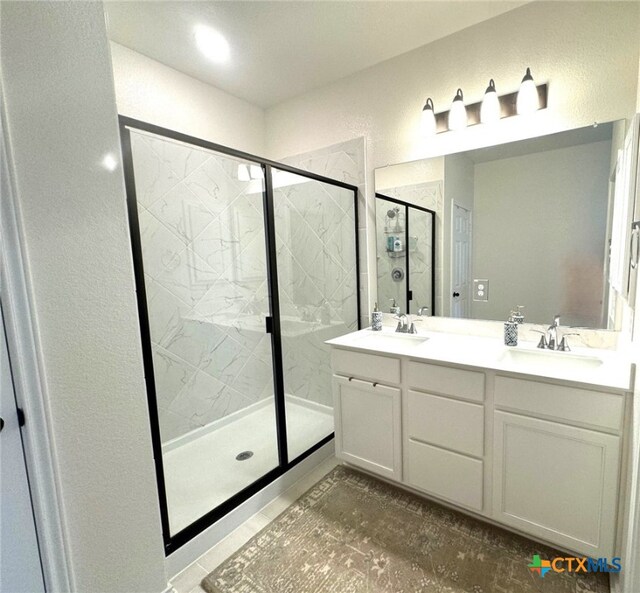 248 Teller Dr, Lockhart, TX 78644 - full bathroom with a shower stall, a sink, and double vanity