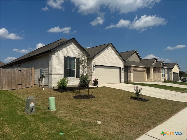 248 Teller Dr, Lockhart, TX 78644 - single story home featuring a front lawn, driveway, fence, brick siding, and an attached garage