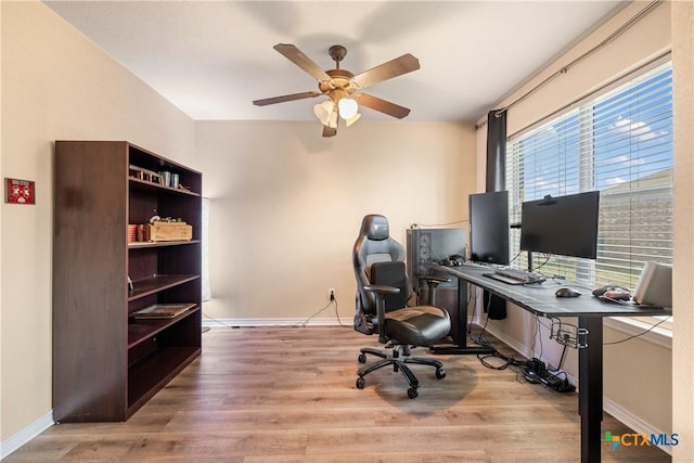 office area with ceiling fan and light hardwood / wood-style floors