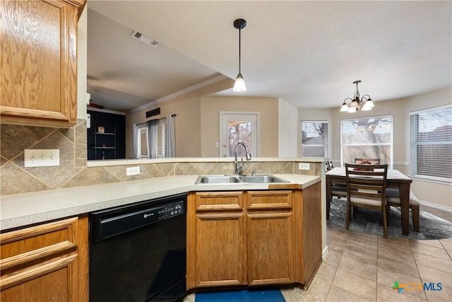 kitchen with sink, black dishwasher, pendant lighting, a chandelier, and light tile patterned floors