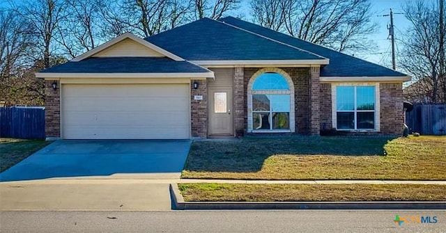 view of front of property with a garage and a front lawn