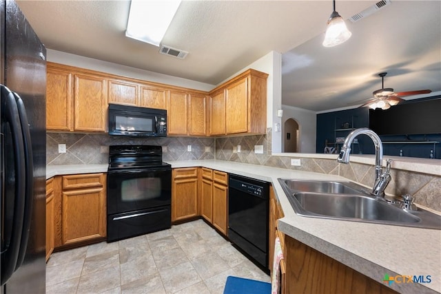 kitchen featuring backsplash, ceiling fan, sink, black appliances, and hanging light fixtures