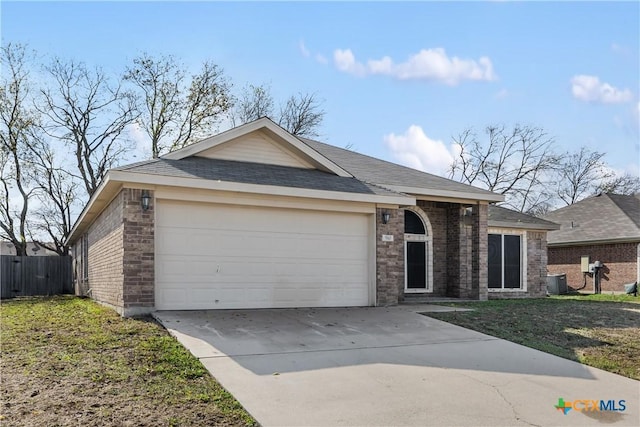 ranch-style home featuring a garage, central air condition unit, and a front yard