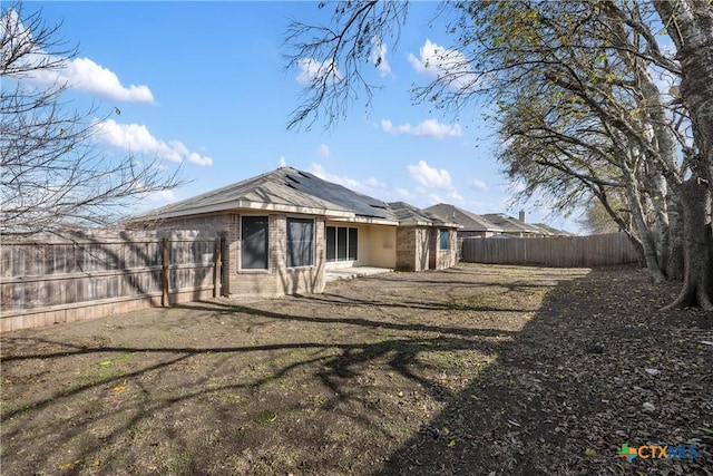 rear view of house featuring a yard