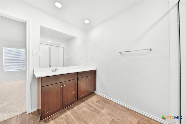 813 Indigo Way, Seguin, TX 78155 - bathroom featuring wood finished floors, baseboards, a shower, vanity, and recessed lighting