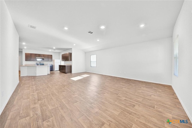 813 Indigo Way, Seguin, TX 78155 - unfurnished living room featuring light wood-type flooring, recessed lighting, and baseboards