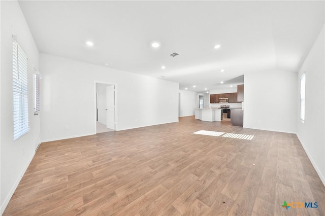 813 Indigo Way, Seguin, TX 78155 - unfurnished living room featuring light wood-style floors, recessed lighting, and baseboards