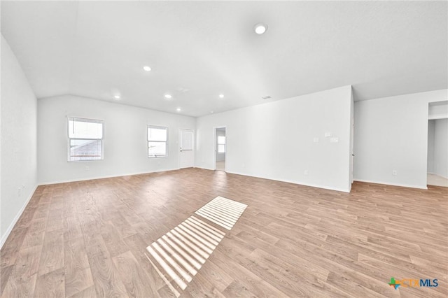 813 Indigo Way, Seguin, TX 78155 - unfurnished living room with light wood-style flooring, recessed lighting, baseboards, and lofted ceiling