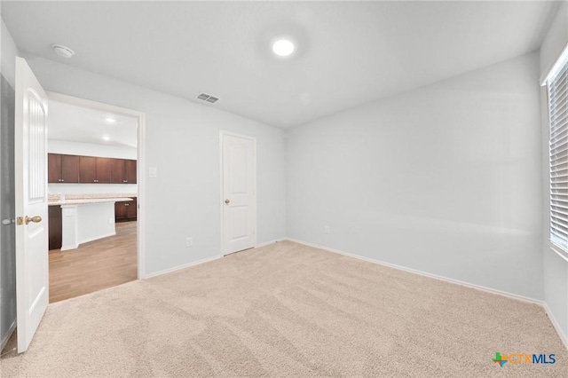 813 Indigo Way, Seguin, TX 78155 - unfurnished bedroom featuring light carpet, baseboards, and multiple windows