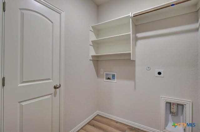 laundry room featuring electric dryer hookup, gas dryer hookup, hookup for a washing machine, and light hardwood / wood-style flooring