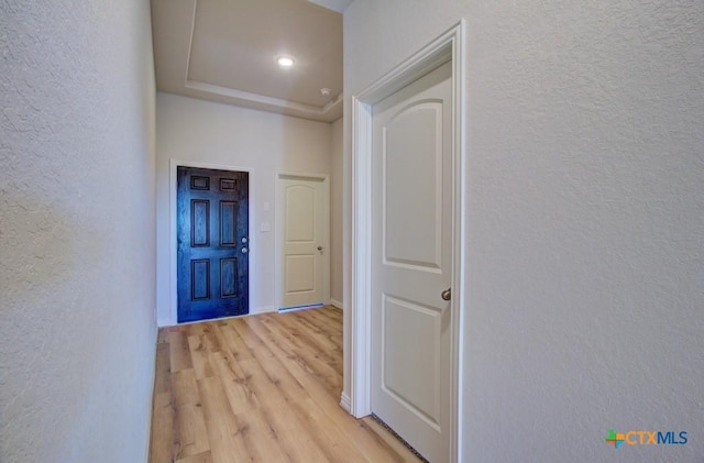 hallway with light hardwood / wood-style floors