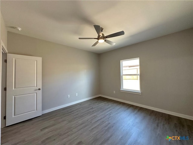 empty room with ceiling fan and dark hardwood / wood-style floors