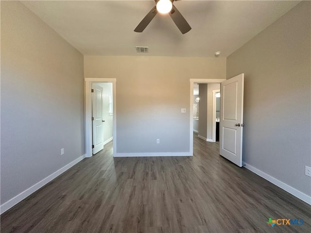 unfurnished bedroom featuring dark wood-type flooring and ceiling fan