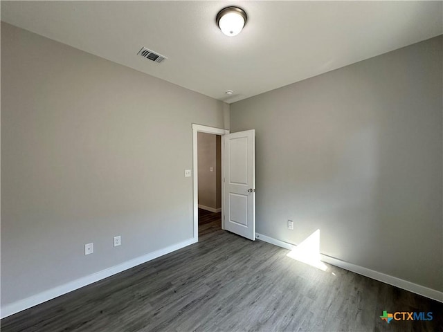 unfurnished room with dark hardwood / wood-style floors