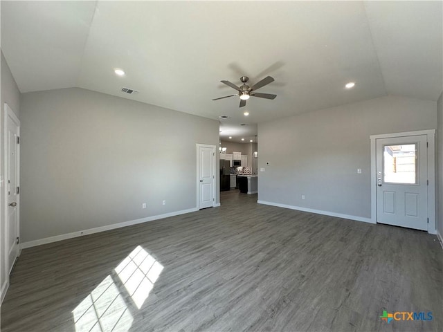 unfurnished living room featuring lofted ceiling, dark hardwood / wood-style floors, and ceiling fan